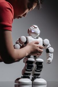 A child explores a humanoid robot, showcasing technology and childhood curiosity.